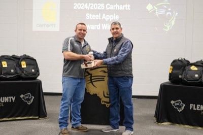 Bobby Pease receiving his award from William Hardy, SVP of Supply Chain at Carhartt