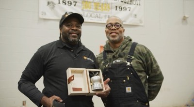 Matthew Bracey receiving his award from Todd Corley, Chief People & Impact Officer of Carhartt