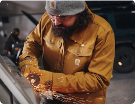 Tradesperson grinding metal