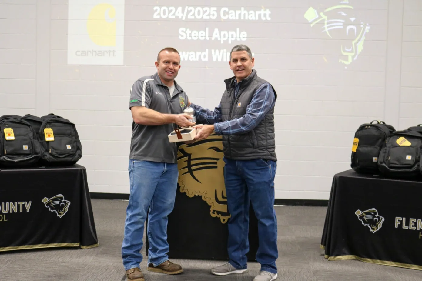 Bobby Pease receiving his award from William Hardy, SVP of Supply Chain at Carhartt