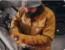 Tradesperson grinding metal