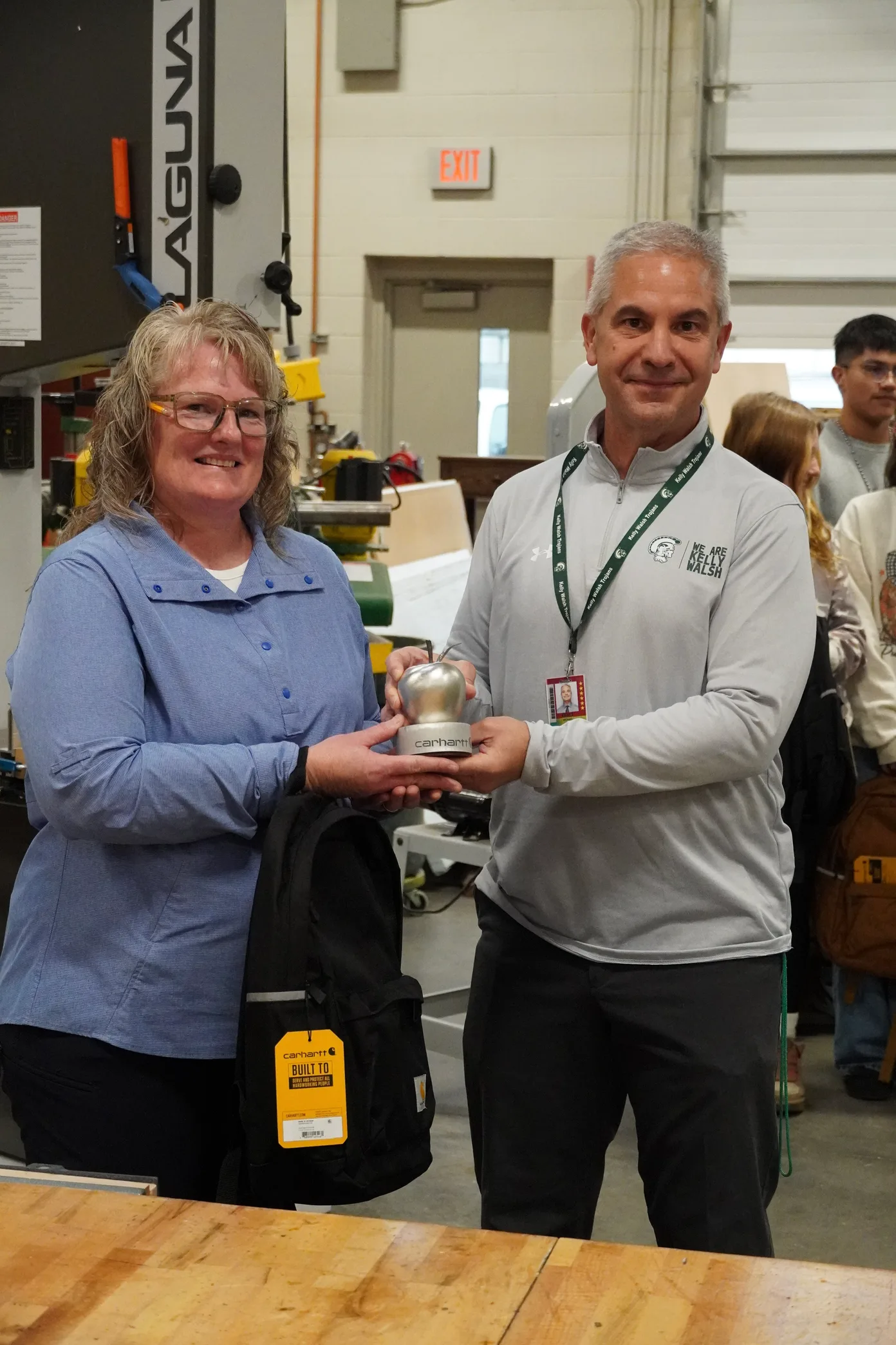 Kora Huffman and Kelly Walsh principal Mike Britt with her Steel Apple Award