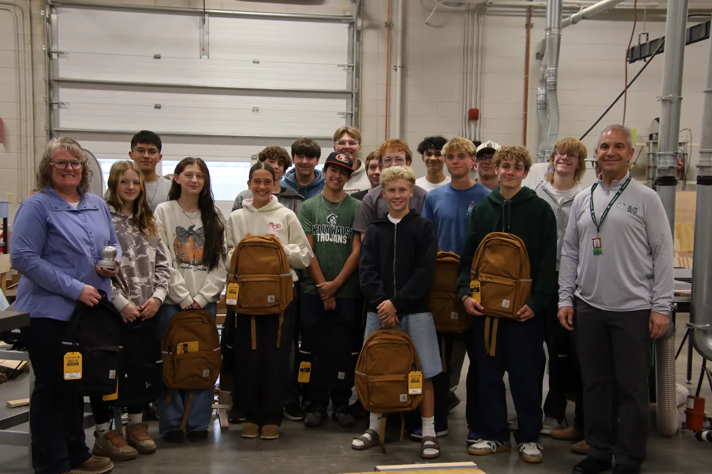 Steel Apple winner Kora Huffman with her Kelly Walsh students and principal Mike Britt and their new Carhartt gear